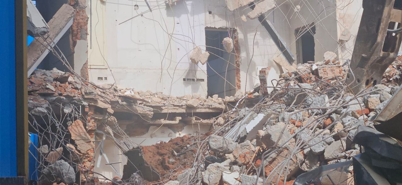 Concrete, brick and reinforcement bars in demolition debris